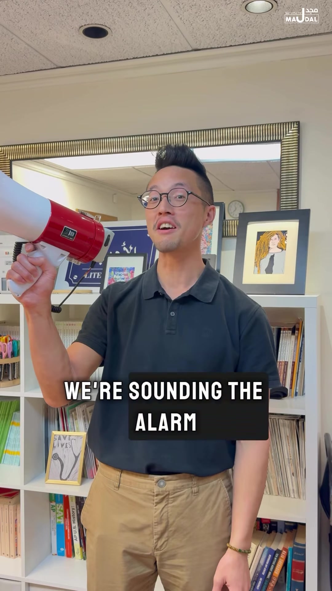 Majdal Center spokesperson holding a megaphone in a Census public-comment Instagram Reel